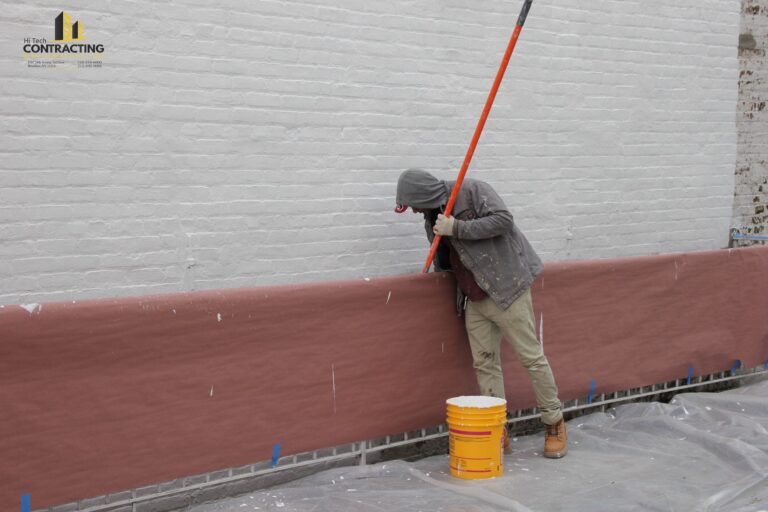 applying waterproofing paint to a revitalized exterior wall 768x512