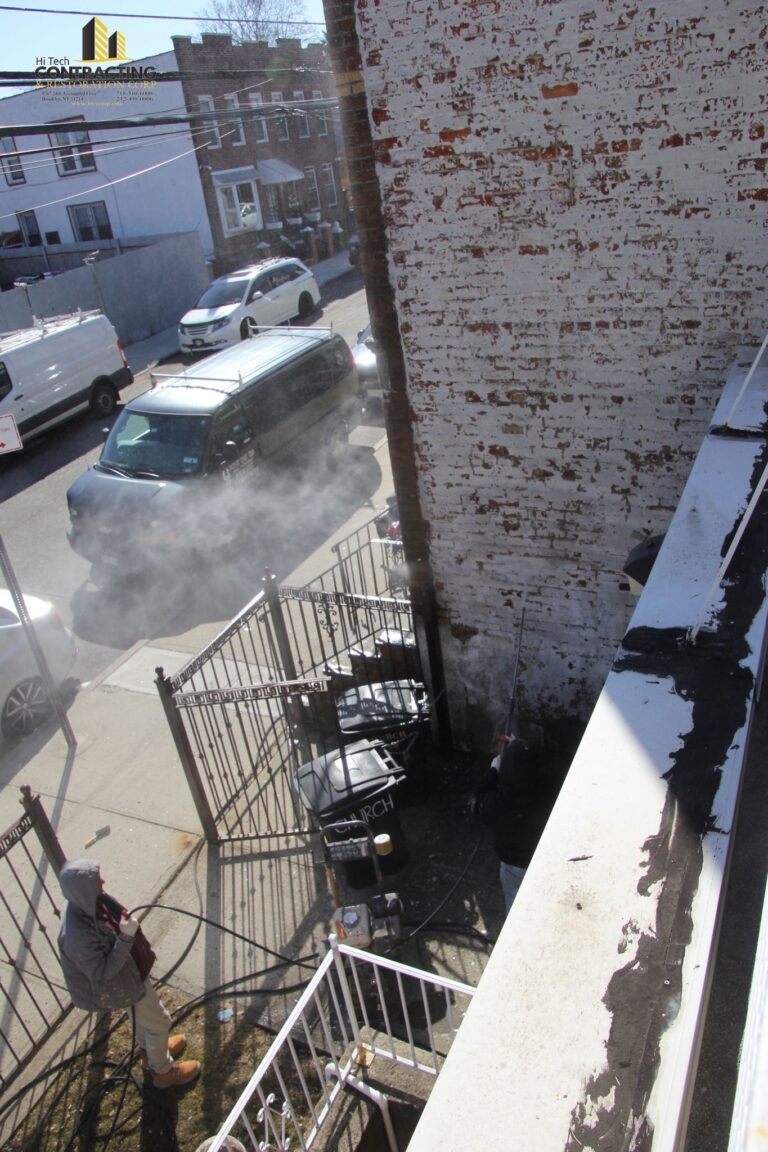 power washing an old exterior wall before restoration 768x1152