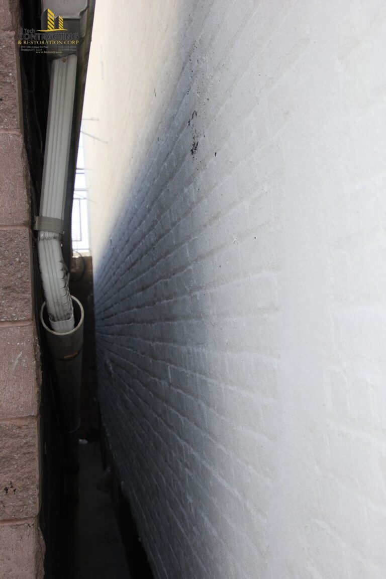 team member applying final touches to restored wall 768x1152